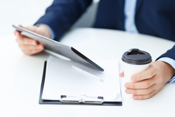 Office worker with tablet and papercup of coffee. - Photo, Image
