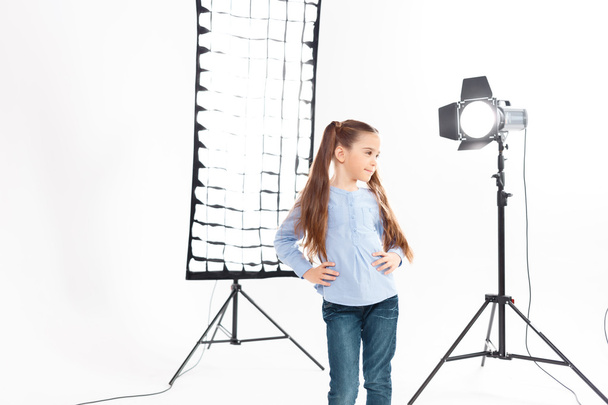 Little model poses heartily during working process. - Foto, afbeelding