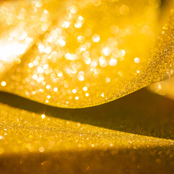 Gouden glitter Kerstmis abstracte achtergrond. Glanzende gouden lichten - Foto, afbeelding