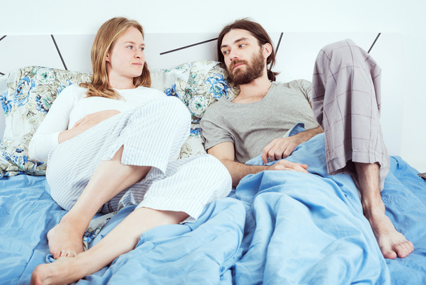 young caucasian couple in bed discussing their problems - Foto, imagen