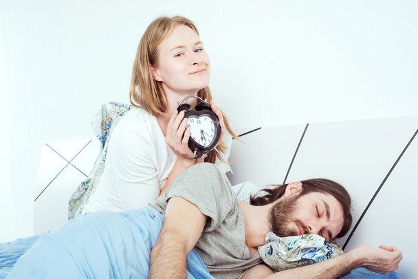 young caucasian couple in bed with alarm clock - Fotoğraf, Görsel