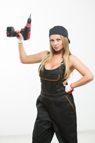 Young sexy female holding a cordless screwdriver - Fotografie, Obrázek