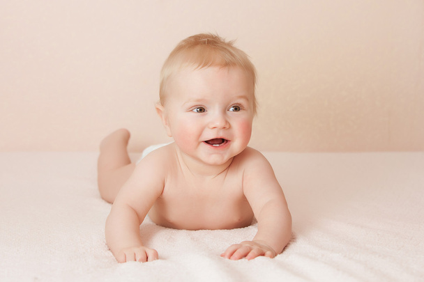 Caucasian baby boy joyfully smiles at camera - Fotó, kép