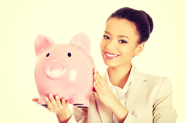 Business woman with a piggybank. - Photo, image