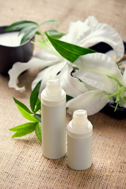 Face/body care concept: lily flower with creams - Photo, Image