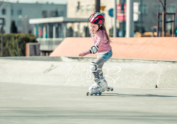 Little pretty girl on roller skates - Фото, изображение