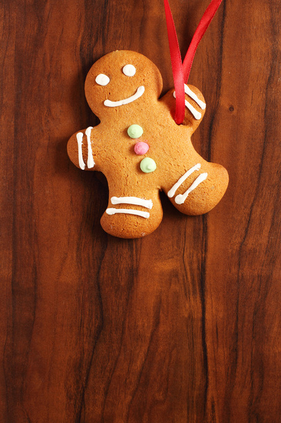 Image of Gingerbread man cookie over brown wooden texture - Photo, Image