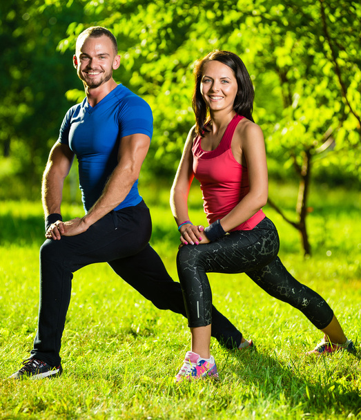 Man and woman doing stretching exercises - Foto, Imagem