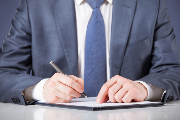 Businessman signing documents - Photo, image