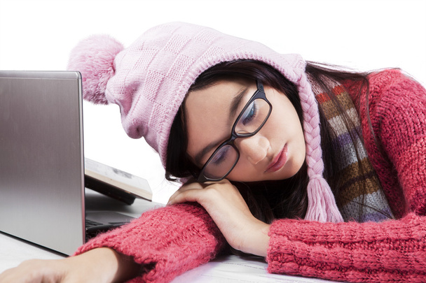 Student in winter clothes sleeping on table - Foto, Imagem