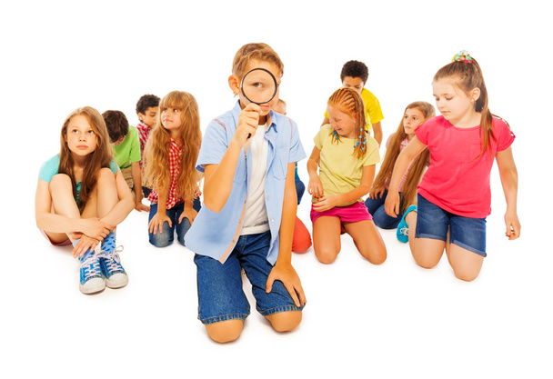 Búsqueda seria de niños en edad escolar con lupa
 - Foto, imagen