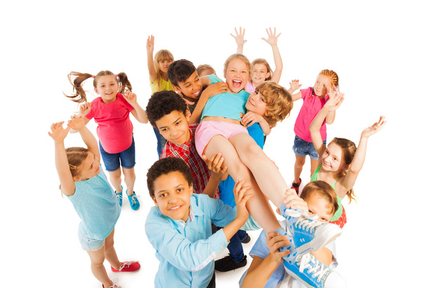 Kids lifting popular classmate and cheering - 写真・画像