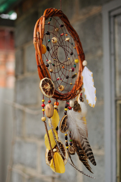 Handmade dream catcher at wall in background - Photo, Image