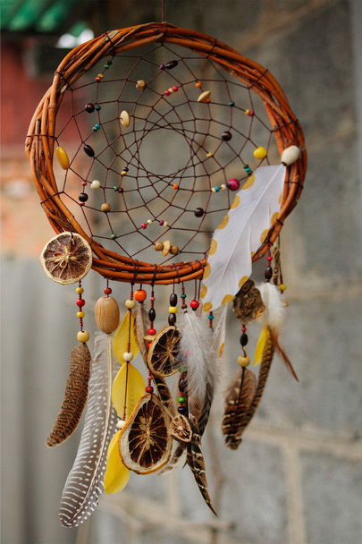 Handmade dream catcher at wall in background - Photo, Image