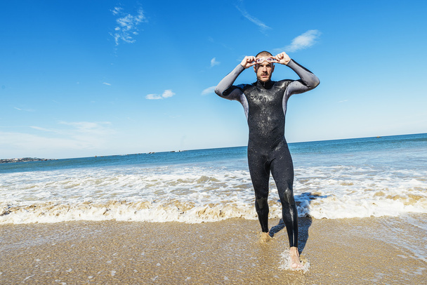 Swimmer rising from the sea after swimming - Valokuva, kuva