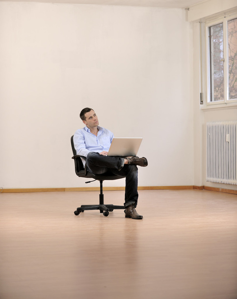 Businessman with laptop in new office - Photo, Image