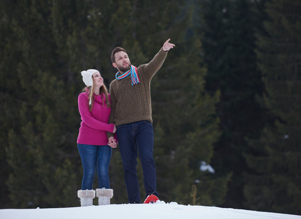 happy young  couple having fun and walking in snow outdoor in nature at beautiful winter day. Health sport and relaxation - Foto, imagen