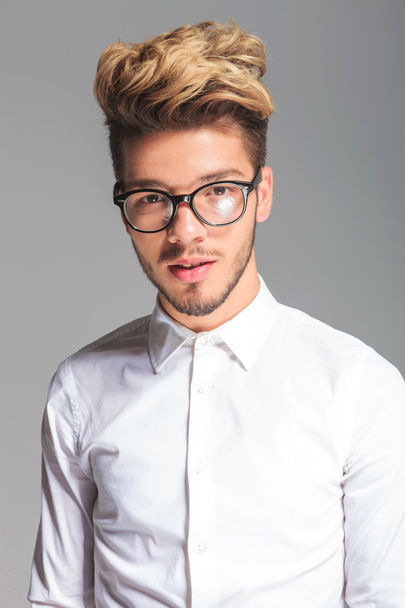 handsome student wearing frames while posing in studio - Φωτογραφία, εικόνα