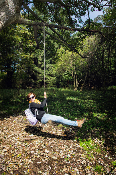 Crazy young woman swing on the rope, hiking theme - Фото, зображення
