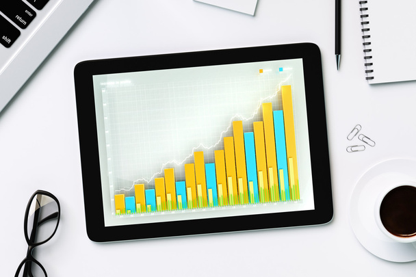 Business chart on the digital tablet screen with cup of coffee a - Photo, Image