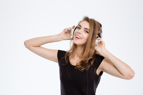 Cheerful woman listening music in headphones - Foto, imagen