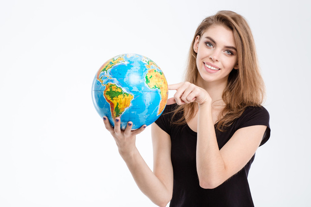 Woman pointing finger on world globe - Foto, imagen