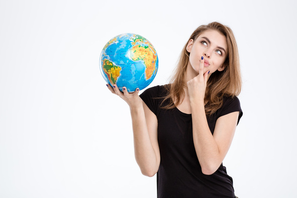 Woman holding world globe and looking up - Valokuva, kuva