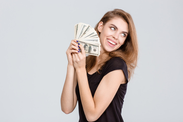 Cheerful woman holding money - Foto, afbeelding