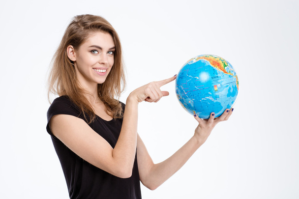 Woman pointing finger on world globe - Foto, afbeelding