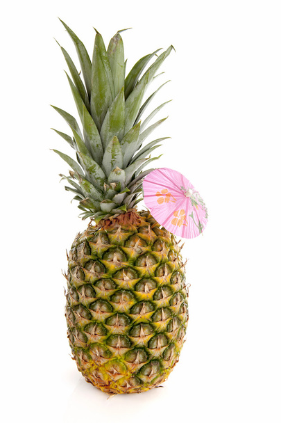 Tropical pineapple with pink umbrella - Valokuva, kuva