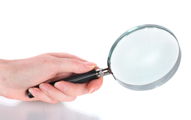 Magnifying glass in hand isolated on white - Foto, immagini