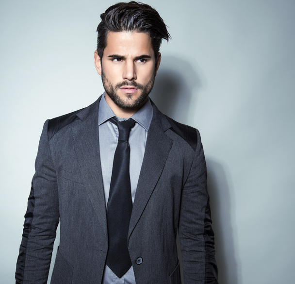 handsome young man in suit on grey background - Φωτογραφία, εικόνα