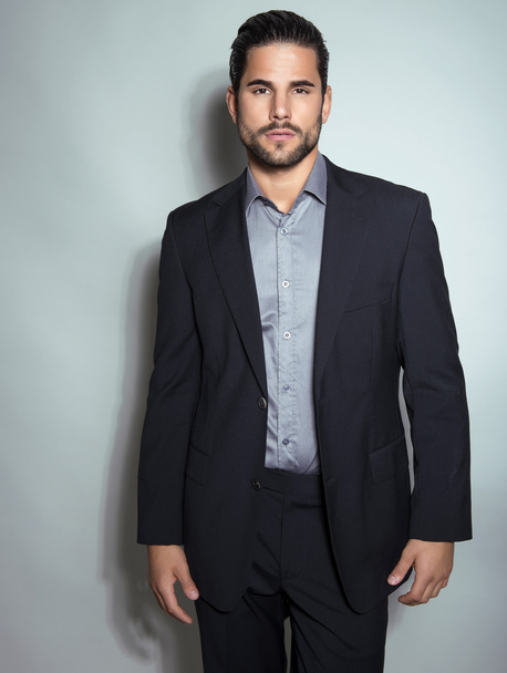 handsome young man in suit on grey background - Photo, image