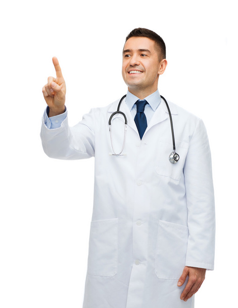 smiling male doctor in white coat pointing finger - 写真・画像