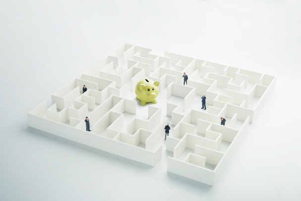 The uncertainty of money and business. Piggy bank hidden inside a maze - Photo, Image