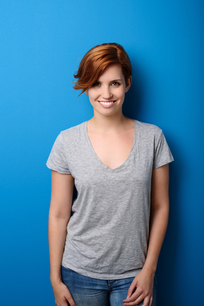 Smiling Woman in Casual Clothing Against Blue - Foto, Bild