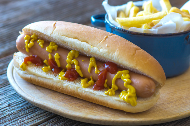 Appetizing hotdog with fresh salad - Фото, зображення