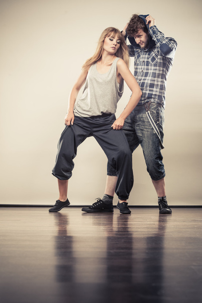 couple of young man and woman dancing hip-hop - Фото, изображение