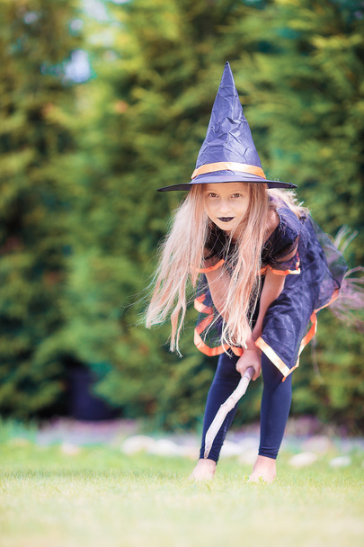 Happy little witch with broom on Halloween. Trick or treat. - Photo, Image