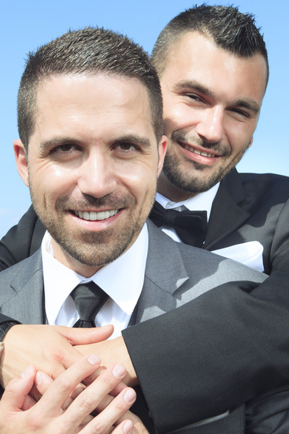 loving gay male couple on their wedding day. - Фото, зображення