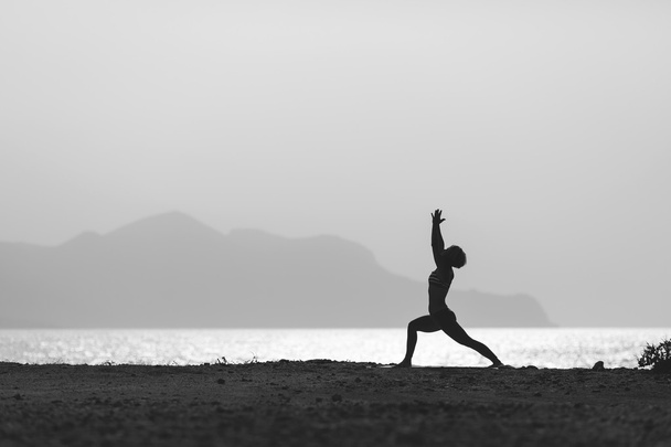 Woman meditating in yoga pose silhouette - Fotó, kép