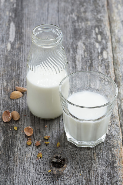fresh nut milk on wooden background - Фото, зображення