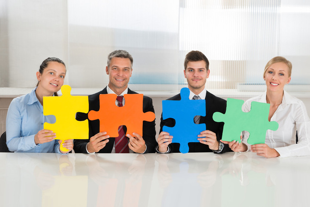 Businesspeople Holding Multi-colored Puzzles - Photo, Image