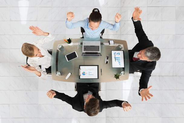 Excited Businesspeople Sitting At Desk - Photo, Image