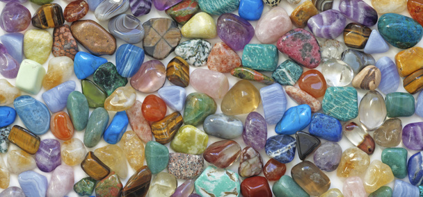 Multicolored tumbled crystal stones background - Photo, Image