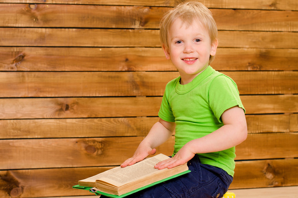 little boy in green shirt with open book - Photo, Image