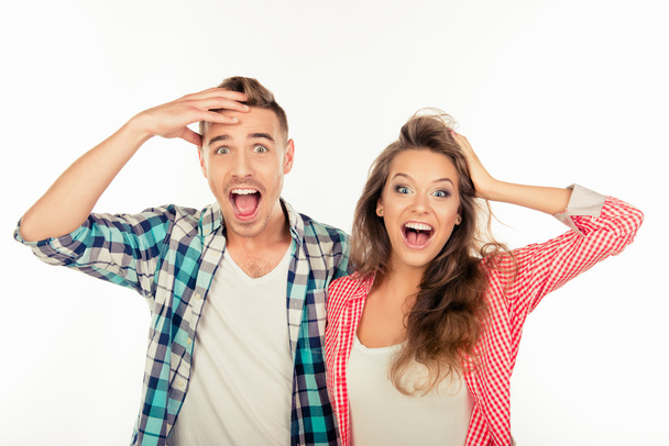Pretty funny cheerful couple  showing surprise - Foto, Imagen
