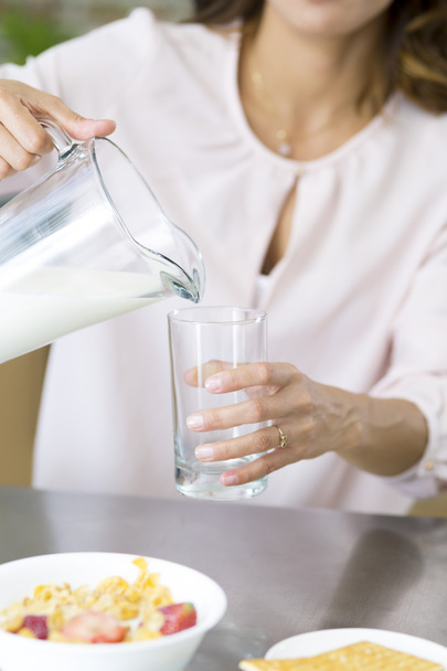 Attractive young woman drinking milk - Foto, immagini