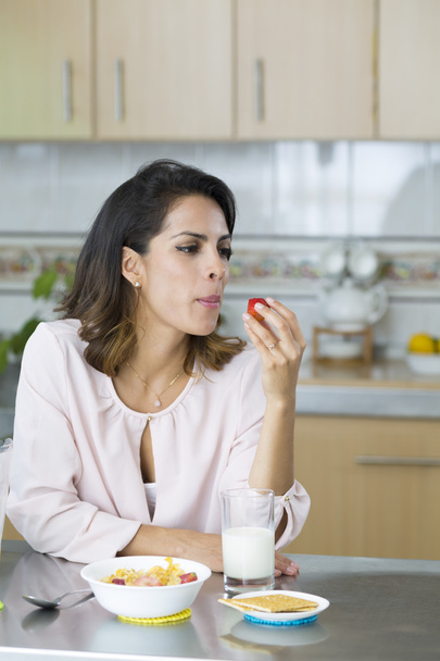 Beautiful Young Woman Eating a Strawberry - Foto, immagini