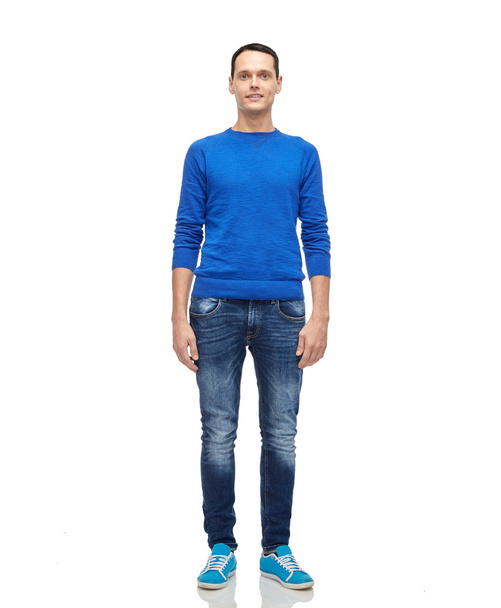smiling young man in blue pullover and jeans - Fotoğraf, Görsel